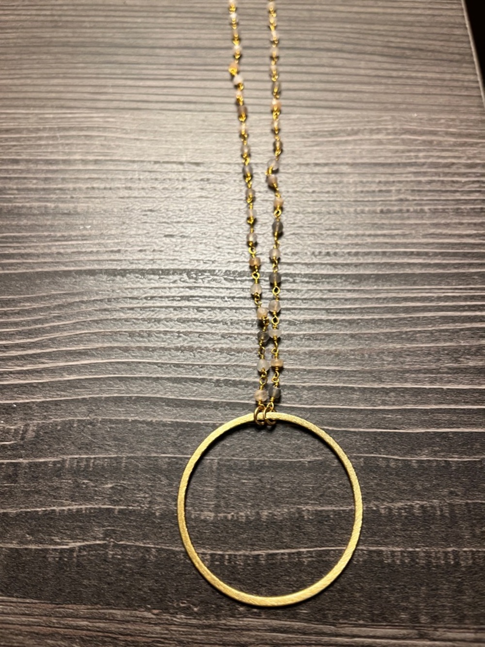 Unbranded gold tone circle pendant necklace.